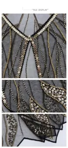 Close-up detail view of 1920s vintage black mesh shawl with gold sequins and beads.
