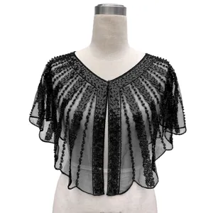 Detailed macro view of black vintage beaded sequined evening capelet on a dress form