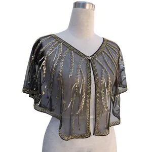 Detailed view of 1920s vintage black mesh shawl with gold sequin and bead patterns