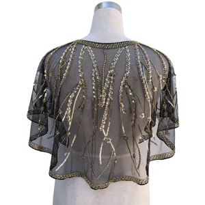 Detailed back view of a 1920s vintage sequined black mesh shawl with gold beadwork