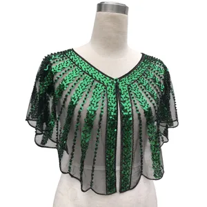 Detail view of shimmering green sequins and black beadwork on evening mesh capelet