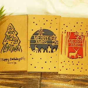 Vintage laser-cut kraft paper Christmas cards with reindeer and snowflake designs.