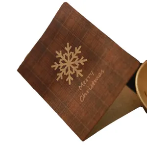 Handmade Merry Christmas greeting card with checkered kraft paper and snowflake