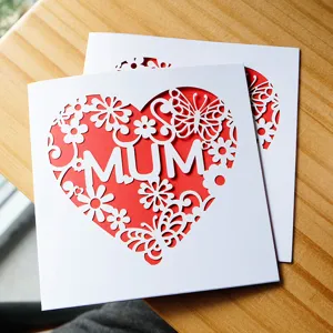 Laser-cut Mother's Day greeting card featuring white heart and butterfly design with MUM text