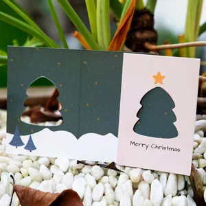 Elegant minimalist hollow Christmas card with gold star patterns and a folding design.