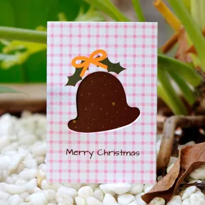 Festive pink plaid Christmas card with bell-shaped cutout and gold star details