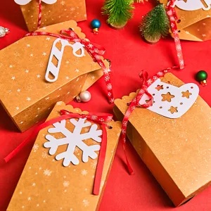 Festive brown kraft paper Christmas candy boxes with decorative red ribbons and tags