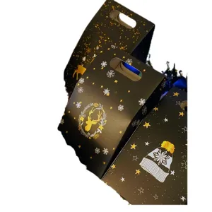 Elegantes cajas de regalo de Navidad negras con diseños dorados de ciervo y copos para fiestas.