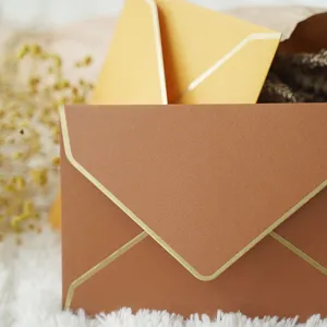 Elegant pearlescent paper envelope with gold foil border for luxury wedding invitations