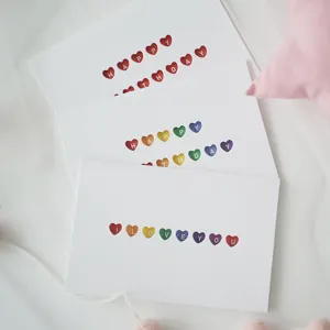 Set of three white cards with rainbow hollow heart patterns for birthday or love messages.