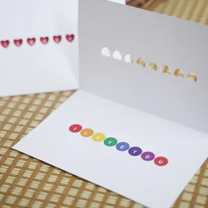 Hollow heart-shaped white greeting card with colorful I Love You message inside for gifts