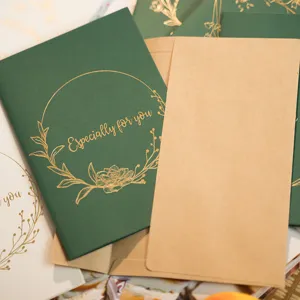 Biglietti d'auguri verde scuro con ghirlanda in lamina d'oro e buste in carta kraft