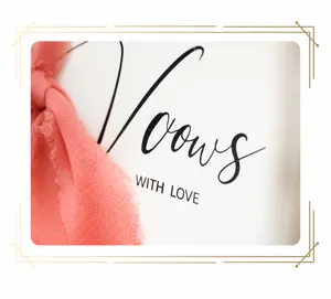 Macro view of 'Vows' wedding vow card detail with romantic coral chiffon ribbon deco