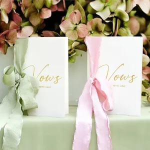 Eleganti biglietti per le promesse di matrimonio bianchi con scritte oro e nastri