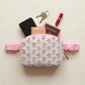 Lightweight pink waist bag with tulip floral print showing capacity for travel essentials