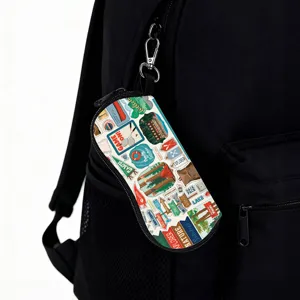 Detailed view of portable sunglasses case with carabiner on backpack, nature print