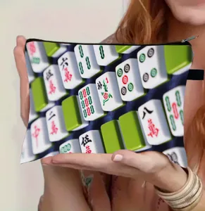 Close-up of large mahjong print makeup pouch held by hand for travel and storage