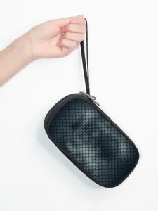 Detailed macro view of portable digital storage bag featuring a unique fish scale texture
