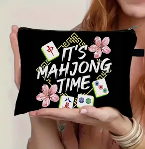Detail view of the black makeup bag featuring a festive 'IT'S MAHJONG TIME' print design