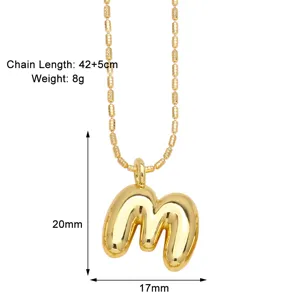 Gold puffy letter m necklace detail showing size 20mm by 17mm and 42 plus 5cm chain length.