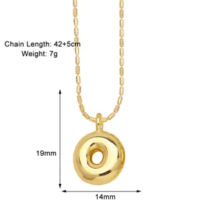 Gold donut pendant necklace with beaded chain, elegant and stylish minimalist fashion jewelry.