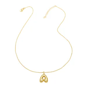 Detailed close-up of the 18K gold plated puffy balloon letter pendant necklace charm.