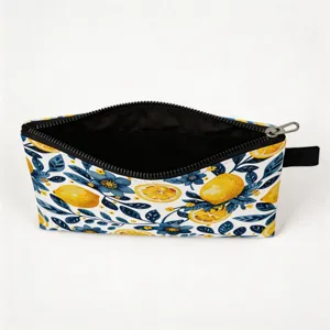 Top view detail of travel cosmetic pouch with vibrant lemon floral print and black lining
