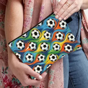Detail of a large capacity pouch with soccer ball pattern held by a stylish model.