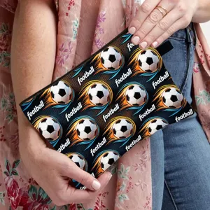 Detailed view of large football pattern pencil case held against a floral cardigan background