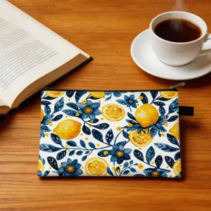 Close-up of lemon and floral print makeup bag on a wooden table