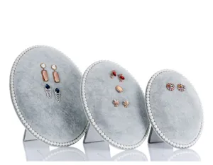 Grey velvet earring display stand with pearl trim, elegant jewelry organizer for studs and drops.