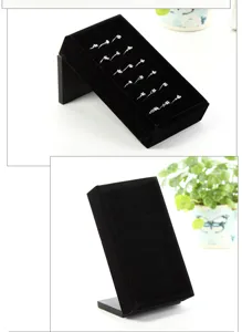 Black velvet ring display stand detail shot, multi-slot jewelry tray for retail counter.