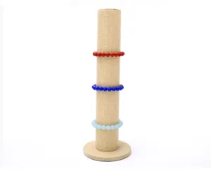 Vertical burlap jewelry display stand detail showing cylindrical pillar with colored bead bracelets.