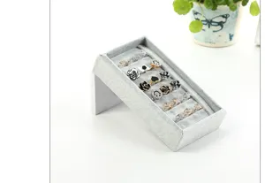 Grey velvet ring display tray detail, slanted slot jewelry holder showcase for earrings and rings.
