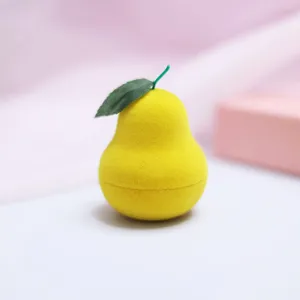 Close-up detail of cute pear shaped jewelry box, velvet yellow ring storage container.