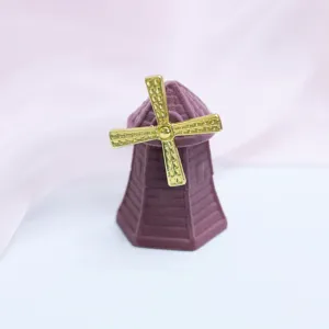 Detail view of a cute windmill shaped velvet ring box, purple and gold jewelry storage.