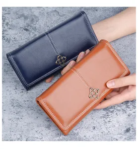 Detail view of blue and brown long leather wallets for women with floral metal clasp