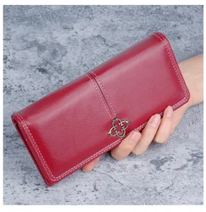 Detailed side view of the burgundy soft leather wallet highlighting metal ornament
