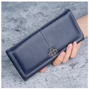 Navy blue soft leather long wallet for women with flower metal clasp and elegant stitching.