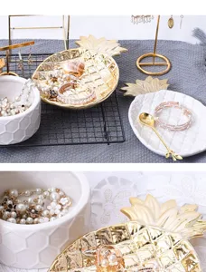 Close up detail of ceramic pineapple jewelry tray, golden plating leaf dish, home decor storage.