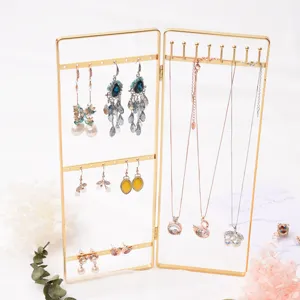 Vintage gold metal jewelry display stand holder for organizing earrings and necklaces.