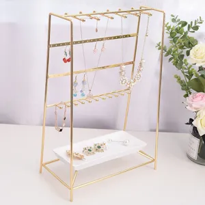 Support de bijoux en métal doré organisateur de colliers avec plateau blanc bureau