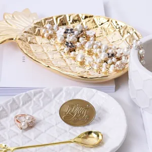 Nordic electroplated golden pineapple leaf ceramic jewelry tray for desktop storage and decor.
