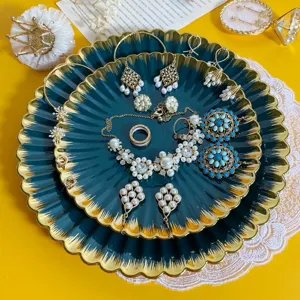 Retro dark green gold rimmed jewelry tray set with elegant pearl earrings and necklaces display.