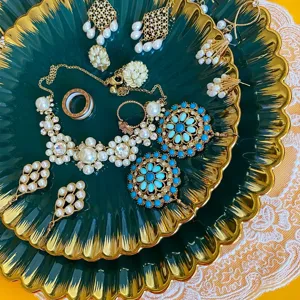 Vintage dark green jewelry tray set with pearls and rhinestones ring necklace display.