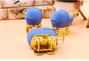 Blue velvet baby stroller jewelry box detail, cute miniature cart design, gold metal wheels.