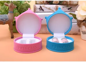 Velvet contact lens jewelry box detail view showing pink and blue crown storage cases with plush finish.
