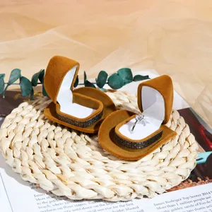 Creative cowboy hat velvet ring box jewelry storage box with slots for rings and earrings.