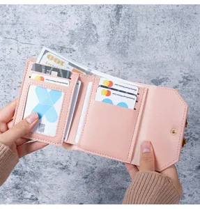 Detailed internal view of pink women's short tri-fold wallet with multiple card slots