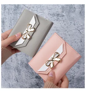 Two elegant women's short wallets in pink and grey showing bowknot and flap details